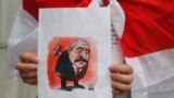 UKRAINE – An activist, a member of the Belarusian diaspora in Ukraine, holds a placard depicting Belarusian President Alexander Lukashenko during a rally outside the Foreign Ministry in Kyiv on May 28, 2021