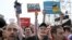 RUSSIA – Protesters shout anti-government slogans holding small posters reading ' Russia is us!', 'I'm over it' at a demonstration against President Vladimir Putin in Pushkin Square in Moscow, Saturday, May 5, 2018