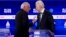 Democratic presidential hopefuls Vermont Senator Bernie Sanders (L) and Former Vice President Joe Biden (R) talk during a break in the tenth Democratic pri