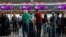 Passengers wait to check in for the last Belavia flight from Kyiv's Boryspil International Airport to Minsk on May 25, 2021.