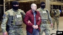 Travel blogger Aleksandr Lapshin is met by Azerbaijani security offers upon his landing in Baku after being extradited from Belarus in 2017. 