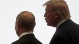 JAPAN -- Russia's President Vladimir Putin and U.S. President Donald Trump walk during the G20 leaders summit in Osaka, June 28, 2019
