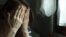 GENERIC -- Woman covering her face with both hands, depression concept, domestic violence