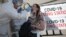 KAZAKHSTAN -- A health worker takes a swab from a woman at a mobile testing station for the coronavirus disease (COVID-19) in Almaty, June 17, 2020