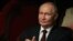In this pool photograph distributed by the Russian state agency Sputnik, Russia's President Vladimir Putin  attends a concert at the Hanoi Opera House in Hanoi on June 20, 2024.