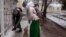 Turkmenistan. Schoolgirls with dog outside.Snowing Ashgabat. February 2020