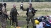 UKRAINE – A pro-Russian fighter holds up a toy found among the debris at the crash site of a Malaysia Airlines jet near the village of Hrabove, Donetsk region, July 18, 2014