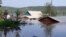 RUSSIA - IRKUTSK REGION, JUNE 29, 2019: Houses in a flooded street. Heavy rains have caused floods in Russia's Irkutsk Region; a state of emergency has been declared in the area. Best quality available. 
