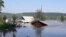 RUSSIA - IRKUTSK REGION, JUNE 29, 2019: Houses in a flooded street. Heavy rains have caused floods in Russia's Irkutsk Region; a state of emergency has been declared in the area. Best quality available. 