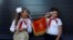 RUSSIA -- A boy and a girl wearing red neckerchiefs, the symbol of the Young Pioneer Soviet-era organisation, play with a horn during a ceremony opening a Russian history interactive museum in Pyatigorsk, September 11, 2020