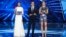 (L to R) Israeli television presenter Lucy Ayoub, Israeli supermodel Bar Refaeli and Israeli television host Erez Tal stand on stage during the first semi-final of the 64th edition of the Eurovision Song Contest 2019 at Expo Tel Aviv on May 14, 2019, in t