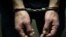 The arrested criminal handcuffed. Hands with handcuffs in the front