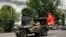 KAZAKHSTAN -- People wearing protective face masks drive a car during the celebrations of Victory Day, which marks the anniversary of the victory over Nazi Germany in World War Two, amid the outbreak of the coronavirus disease (COVID-19) in Almaty, Kazakh