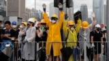 CHINA -- Protesters react to police warning as they attempt to block a ceremony in Hong Kong on Monday, July 1, 2019. 