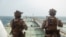 This US Marine Corps handout photograph taken on July 16, 2026, by US Central Command Public Affairs reportedly shows US Marines from the 11th Marine Expeditionary Unit conducting a verification boarding aboard M/T Wen Yao in the Gulf of Oman.