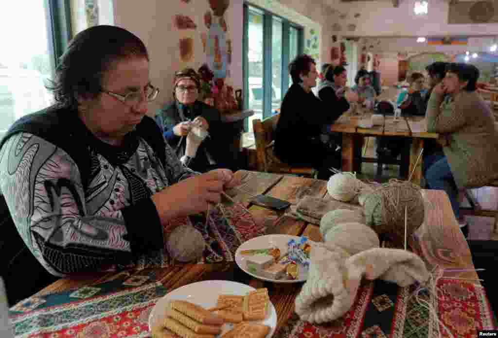 A woman knits in a hotel in the Armenian town of Goris that now accommodates people who fled fighting over the breakaway region of Nagorno-Karabakh. Goris is located about 40 minutes away from the so-called Lachin Corridor, a narrow strip of territory, now held by Armenian forces, that connects Karabakh with Armenia.&nbsp;