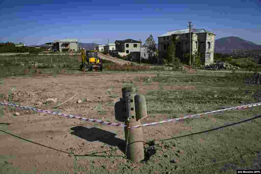 An unexploded, Russian-made BM-30 Smerch rocket is seen on October 12, 2020 in the outskirts of Stepanakert, known to Azerbaijanis as Khankendi, the main town in the breakaway region of Nagorno-Karabakh. Though Russia is a co-chair of the Organization for Security and Cooperation in Europe group coordinating negotiations between Armenia and Azerbaijan, it has sold weapons&nbsp; to both sides of the conflict.