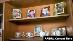 Photos displayed in Denis Mikhailenko's home, showing the teenager as a young boy.