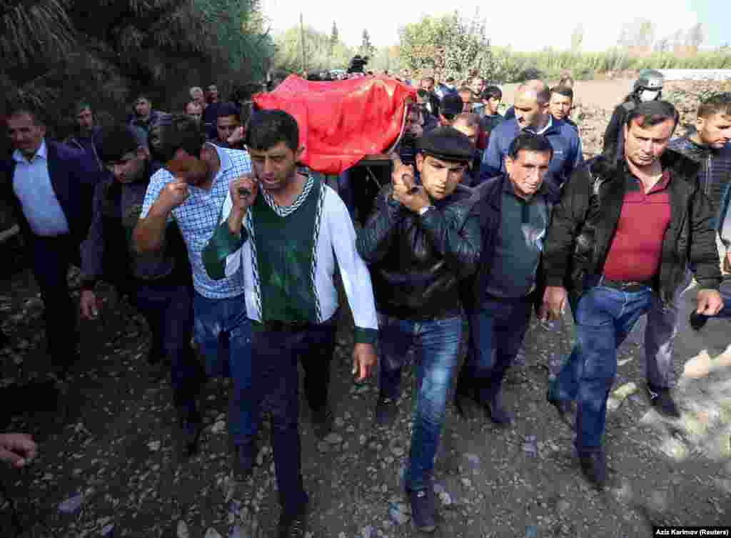 AZERBAIJAN -- Mourners carry a coffin during the funeral of 7-year-old Aysu Isgandarova, who according to relatives and local media was killed by recent shelling in the course of a military conflict over the breakaway region of Nagorno-Karabakh, in the vi