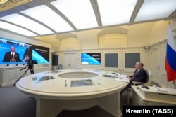 Russian President Vladimir Putin listens to U.S. President Joe Biden as he attends a virtual global climate summit via a video link on April 22, 2021.