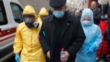 UKRAINE -- Ukrainian medical workers wearing protective gear escort a fake patient during a medical training exercise in case of detection of patients with the COVID-19 coronavirus symptoms, at the Oleksandrivska Clinical Hospital in Kyiv, February 28, 20