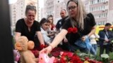 RUSSIA -- TATARSTAN -- A woman places a toy at a makeshift memorial for victims of the shooting at School No. 175 in Kazan on May 11, 2021.
