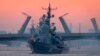 RUSSIA -- A warship floats past drawbridges rising above the Neva River during preparations for the Naval parade in St. Petersburg, July 20, 2020