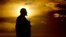 RUSSIA -- The sun sets behind a Lenin statue during the 2018 soccer World Cup in Podolsk, June 28, 2018