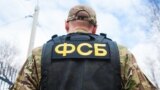 Russian FSB officer in assault gear. Translation: "FSB". Russian Federal security service - Shutterstock