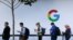 (FILES) In this file photo taken on October 4, 2017, people wait to enter a Google product launch event on at the SFJAZZ Center in San Francisco, California.
