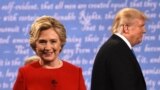 U.S. -- Democratic nominee Hillary Clinton (L) and Republican nominee Donald Trump leave the stage after the first presidential debate at Hofstra University in Hempstead, New York, September 26, 2016