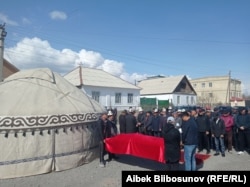 Men gather in Balykchy, Kyrgyzstan on April 8, 2021 for the funeral of Aizada Kanatbekova.
