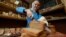 Russia -- An employee cuts bread at German Sterligov's food store in central Moscow, May 26, 2017
