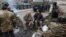 NAGORNO-KARABAKH -- Ethnic Armenian soldiers watch military vehicles of the Russian peacekeeping forces driving along a road in Lachin in the region of Nagorno-Karabakh, November 13, 2020