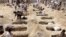 Yemenis dig graves for children, who where killed when their bus was hit during a Saudi-led coalition air strike, that targeted the Dahyan market the previous day in the Huthi rebels' stronghold province of Saada on August 10, 2018. An attack on a bus at 