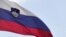Slovenia - Slovenia's national flag flutters next to Nova Ljubljanska Banka (NLB) building in Ljubljana, 23Jul2012