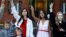 Belarus - Women hold flowers as they attend an opposition demonstration to protest against presidential election results, in front of the Church of Saints Simon and Helena at the Independence Square in Minsk, 28aug2020