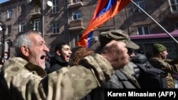 Opposition supporters march through the streets of Yerevan on February 26, 2021 to demand Prime Minister Nikol Pashinian's resignation over his handling of the 2020 war with Azerbaijan.