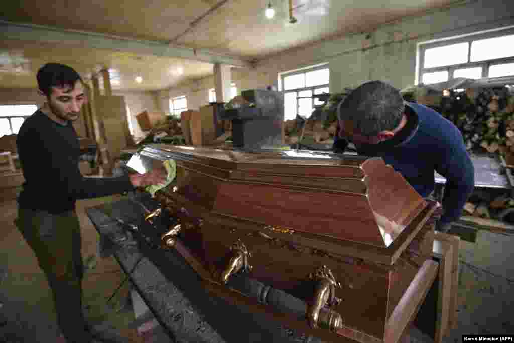 NAGORNO-KARABAKH -- Men make a coffin at a furniture workshop, which totally switched its business to casket production amid the ongoing military conflict between Armenia and Azerbaijan over the breakaway region of Nagorno-Karabakh, in the breakaway regi
