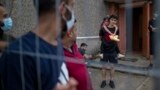 Migration Lithuania Belarus -- Migrants from Iraq look at journalists at the refugee camp in the village of Verebiejai, Lithuania, Sunday, July 11, 2021. 