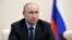 RUSSIA -- Russian President Vladimir Putin listens during a meeting at the Novo-Ogaryovo residence outside Moscow, Russia, Tuesday, April 17, 2018. 