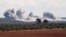 SYRIA -- Smoke billows over the village of Qaminas, about 6 kilometres southeast of Idlib city in northwestern Syria, following reported Russian air strikes in northwestern Syria, March 1, 2020