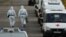 Medical specialists wearing protective gear walk past ambulances outside a hospital for patients infected with the coronavirus disease (COVID-19) on the outskirts of Moscow, Russia October 15, 2020. REUTERS/Maxim Shemetov