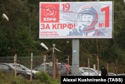 Showing a Soviet cosmonaut, a 2021 election billboard in the Siberian city of Irkutsk proclaims "Communists are always first."