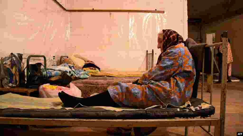 An elderly woman rests in a basement used as a bomb shelter in Stepanakert (called Khankendi in Azerbaijani), the main town in the disputed region of Nagorno-Karabakh.