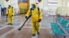 RUSSIA -- Specialists wearing personal protective equipment (PPE) spray disinfectant while sanitizing the Rizhsky Railway Station, one of the measures to curb the spread of the coronavirus disease (COVID-19), in Moscow, June 17, 2021