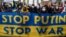 GERMANY – Demonstrators display a placards criticising Russian President Vladimir Putin during a protest at Berlin's Brandenburg Gate on January 30, 2022