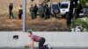 VENEZUELA -- Soldiers are seen inside the Generalisimo Francisco de Miranda Airbase "La Carlota" as an opposition supporter takes cover, in Caracas, April 30, 2019