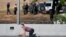 VENEZUELA --  Soldiers are seen inside the Generalisimo Francisco de Miranda Airbase "La Carlota" as an opposition supporter takes cover, in Caracas, April 30, 2019