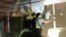 Kazakhstan - A group of young people is trying to get through the window into the apartment where the alleged kidnapper of a five-year-old girl lived. Satpayev, Karaganda region, 24Jull2020.